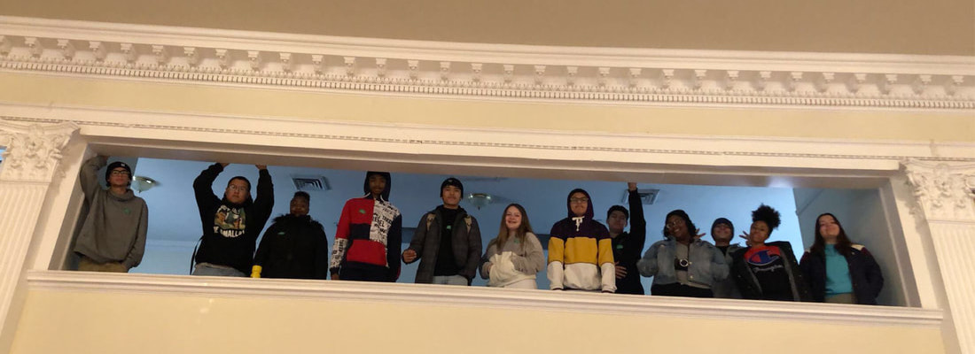Group of students posing on balcony